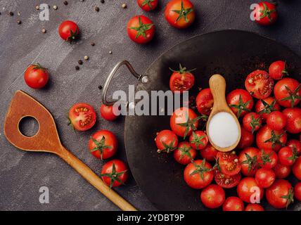Cherry tomatoes on against black stone surface Stock Photo
