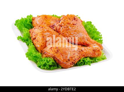 Raw uncooked marinated chicken legs on plate Stock Photo