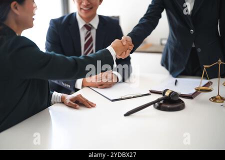 Lawyer consultant shaking hand with client sign contract agreement document. in law firm. Business meeting Handshake. Â Stock Photo