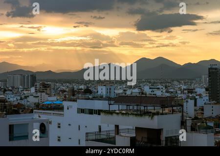 This is a city view of the center of Nha Trang with mountains in the distance during sunset on June 01, 2023 in Nha Trang, Vietnam Stock Photo