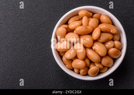 Delicious nutritious canned beans in tomato, with salt and spices Stock Photo