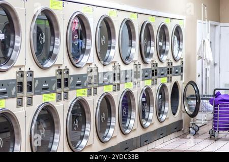 Miami, USA - September 09, 2019: industrial washing machines in a public laundromat, coin laundry service Stock Photo