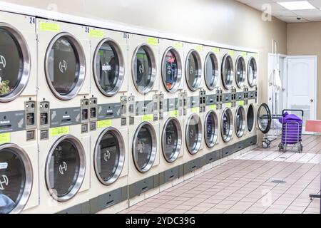 Miami, USA - September 09, 2019: industrial washing machines in a public laundromat, coin laundry service Stock Photo