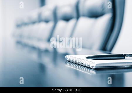 Closeup of notepad kept on table in empty room Stock Photo