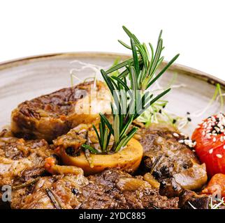 Grilled bbq steaks with fresh herbs and tomatoes Stock Photo