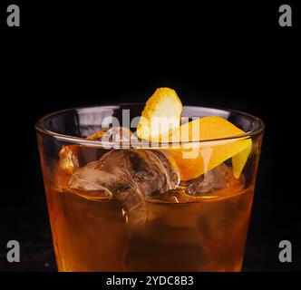 Old-fashioned cocktail with ice and orange peel Stock Photo