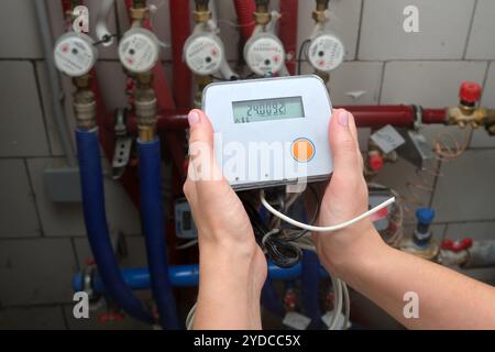 Replacement of the heat meter for measuring the heating supply in the apartment Stock Photo