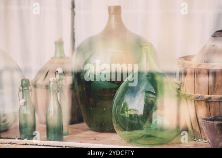 Old empty wine bottles behind the glass Stock Photo