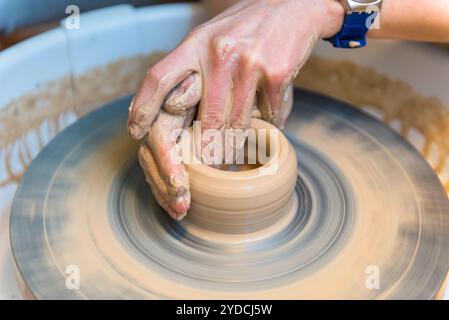 Pottering - creating a clay cup in process Stock Photo