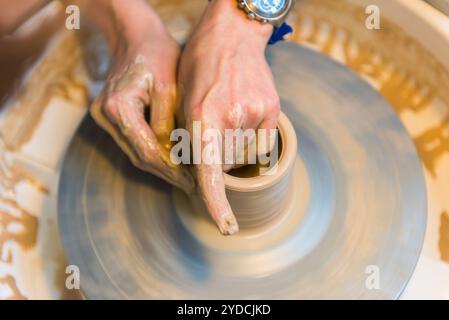 Pottering - creating a clay cup in process Stock Photo
