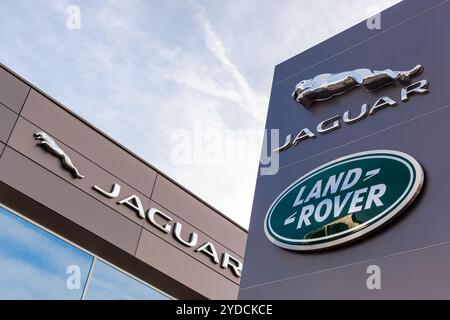 Jaguar Land Rover brand logo blue sky background Stock Photo