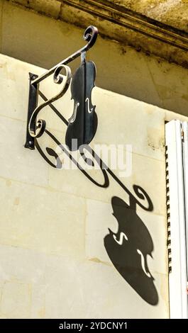Metal cut-out violin hanging advertising sign for luthier and music teacher - Tours, Indre-et-Loire (37), France. Stock Photo