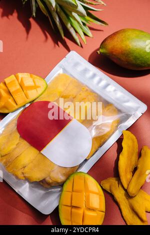Pack of dried mango slices and raw mango Stock Photo