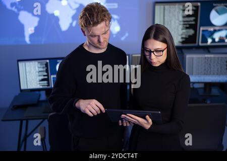Two professionals in cyber security team working to prevent security threats, find vulnerability and solve incidents Stock Photo