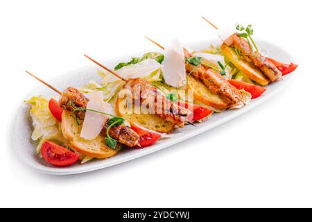 Trendy Caesar salad with chicken on wooden skewers Stock Photo