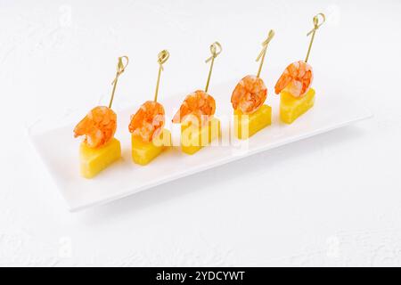 Canapes with shrimp and pineapple on plate Stock Photo