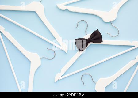 White wooden hangers on blue background Stock Photo