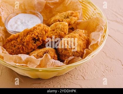 Crisp crunchy golden chicken legs and wings deep fried Stock Photo