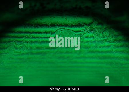 Green fantastic lines, red liquid on a dark background, colourful abstract, line of light, red on black, surrealistic art Stock Photo