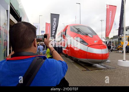 People viewing a new Hitachi Frecciarossa 1000 high speed train for Trenitalia at world public transport show Innotrans, Berlin, September 2024 Stock Photo