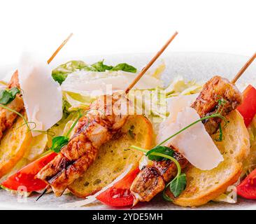 Trendy Caesar salad with chicken on wooden skewers Stock Photo