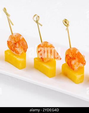 Canapes with shrimp and pineapple on plate Stock Photo