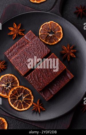 Rectangular chocolate candies with mousse and waffles on a dark concrete background Stock Photo