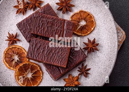 Rectangular chocolate candies with mousse and waffles on a dark concrete background Stock Photo