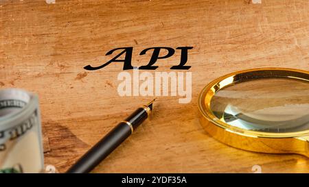 API (application program interface). The concept of technology and development. Phrase, words, text API written on paper, front view. Stock Photo