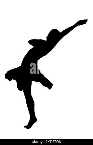 A striking silhouette of a person energetically jumping high into the air with their arms joyfully outstretched to the sides Stock Photo