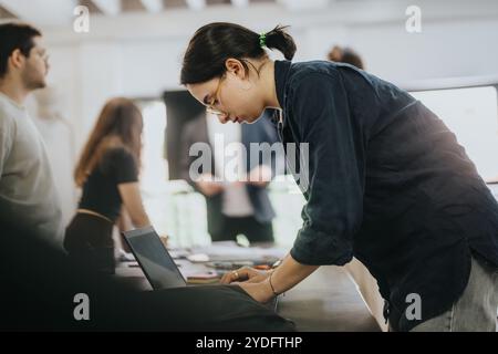 Students collaborating on school projects in a classroom setting Stock Photo