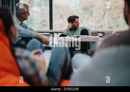 Professor engaging with students in casual classroom setting Stock Photo