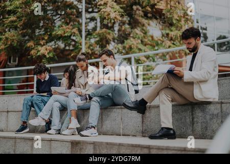 High school students learning outdoors with guidance from professor Stock Photo
