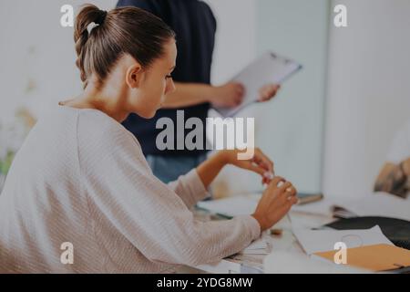 High school students collaborating on project with professor at home Stock Photo