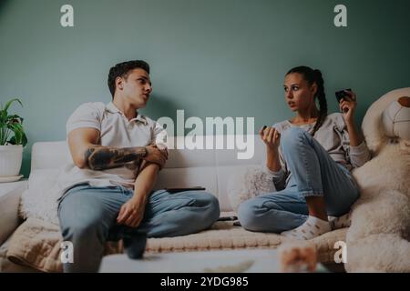 Young couple having a serious conversation at home Stock Photo
