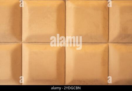 Background of Velvet Fabric Upholstery Panel with 3D Squares, Bed Headboard, Modern Luxury Quilted Velvet. Ochre Color. Stock Photo
