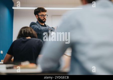 Professor assisting students during class in a modern classroom setting Stock Photo