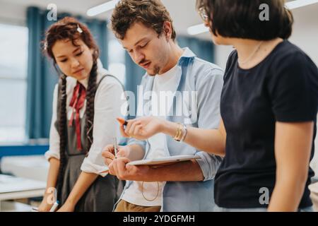 Group of students collaborating on a school project together Stock Photo