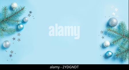 Blue and Silver Christmas Banner Composition with fir branches and silver baubles on light blue background, template, copy space. Christmas festive cr Stock Photo