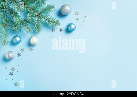 Blue and Silver Christmas Composition with fir branches, baubles and stars on light blue background, border, copy space. Christmas festive creative de Stock Photo