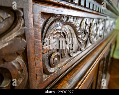 Fragment of a carved pattern on an old wooden chest of drawers Stock Photo