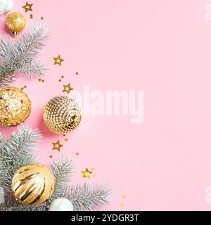 Pink and Golden Christmas Background with fir branches and gold baubles, top view, copy space. Creative and shine Christmas design concept layout. Stock Photo