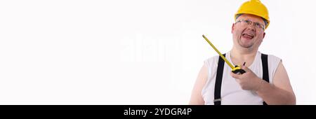 A Cheerful Construction Worker holding a Measuring Tape, illustrating joy in their craft Stock Photo