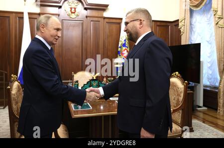 Moscow, Russia. 25th Oct, 2024. Russian President Vladimir Putin, left, greets Federal Customs Service head Valery Pikalev as he arrives for a one-on-one meeting at the Kremlin, October 25, 2024 in Moscow, Russia. Credit: Mikhail Metzel/Kremlin Pool/Alamy Live News Stock Photo