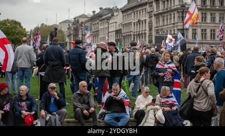 London, UK. 26th Oct, 2024. Protesters gather at the Parliament Square during the demonstration. Supporters of ex English Defence League (EDL) leader Tommy Robinson, whose real name is Stephen Yaxley-Lennon joined the Uniting the Kingdom protest in London, while a counter protest organized by Stand Up to Racism gathers on the North end of Whitehall in London. Credit: SOPA Images Limited/Alamy Live News Stock Photo