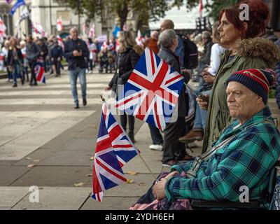 London, UK 26th October 2024 . Tommy Robinson supporters with union jack flags at Parliament Square . Stock Photo