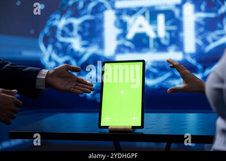 Admin running AI cognitive computing tech on chroma key tablet to simulate computerized model. Close up of isolated screen device used by IT professional to do data mining with artificial intelligence Stock Photo