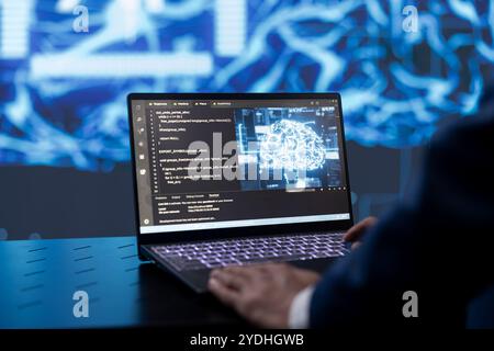 Computer scientist analyzing complex AI brain models on laptop. Close up shot of employee at work using machine learning on notebook to develop artificial intelligence technology Stock Photo