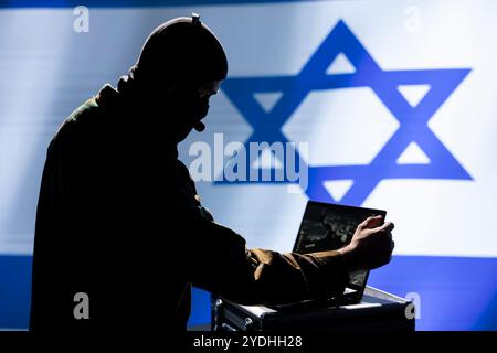 Israel Mossad agent working on laptop, analyzing aerial reconnaissance data to come up with global conflict winning strategy. IDF operative controlling drones attacking strategic targets Stock Photo