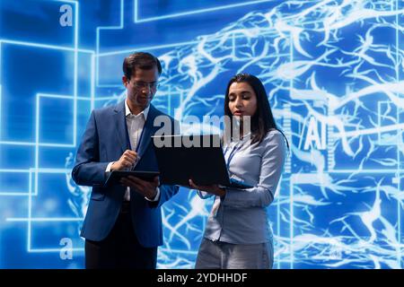 AI researcher and colleague working with artificial intelligence neural networks modern lab. Computer scientists collaborating on developing AI system in high tech workplace Stock Photo